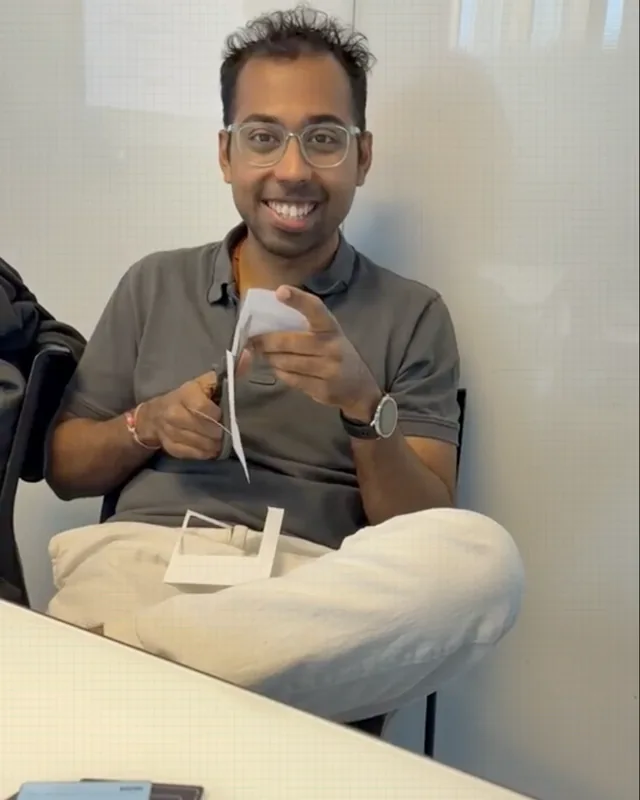 Yash smiling while cutting the first UNICORN cards by hand